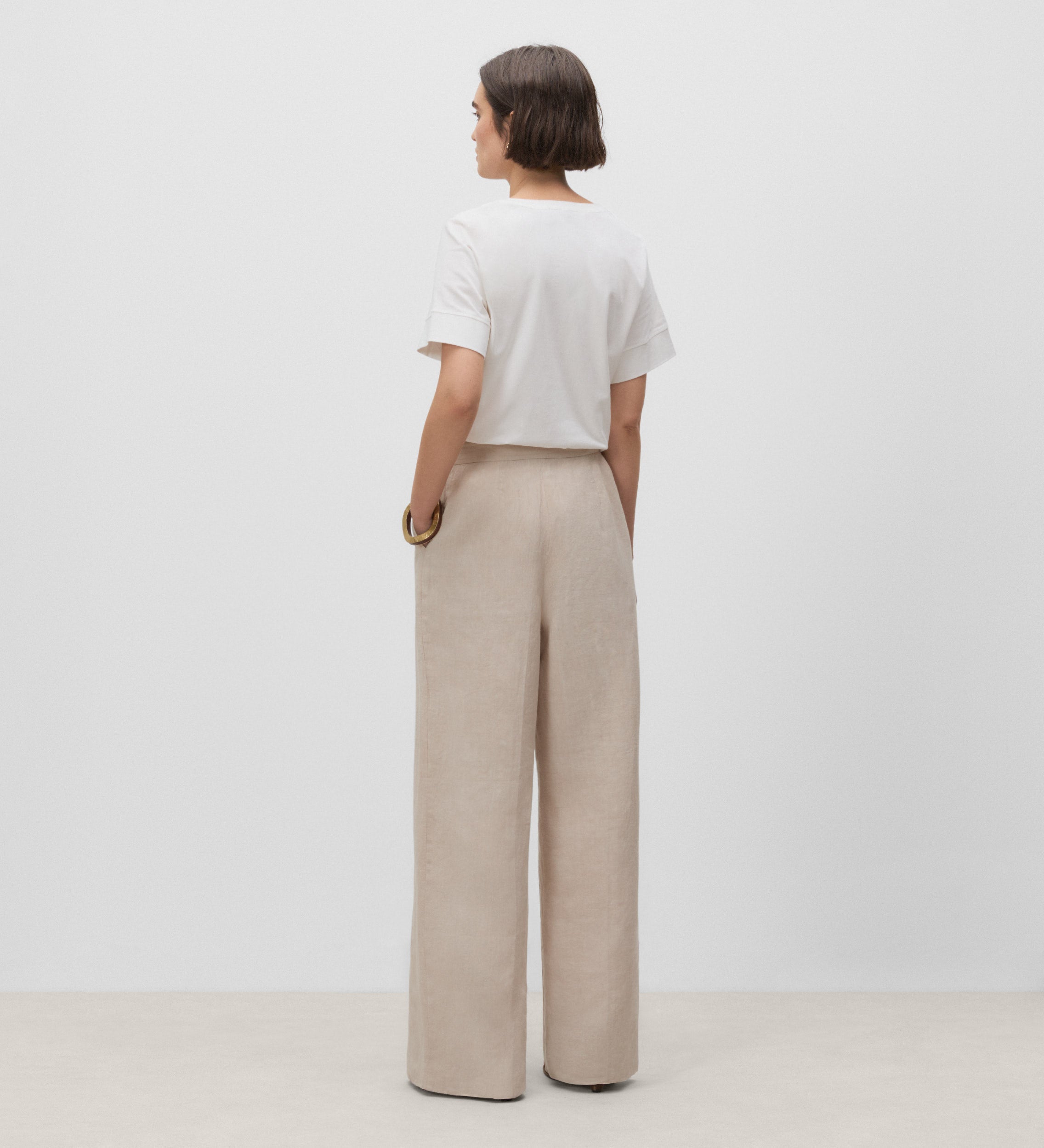 Trousers with stitched waistband