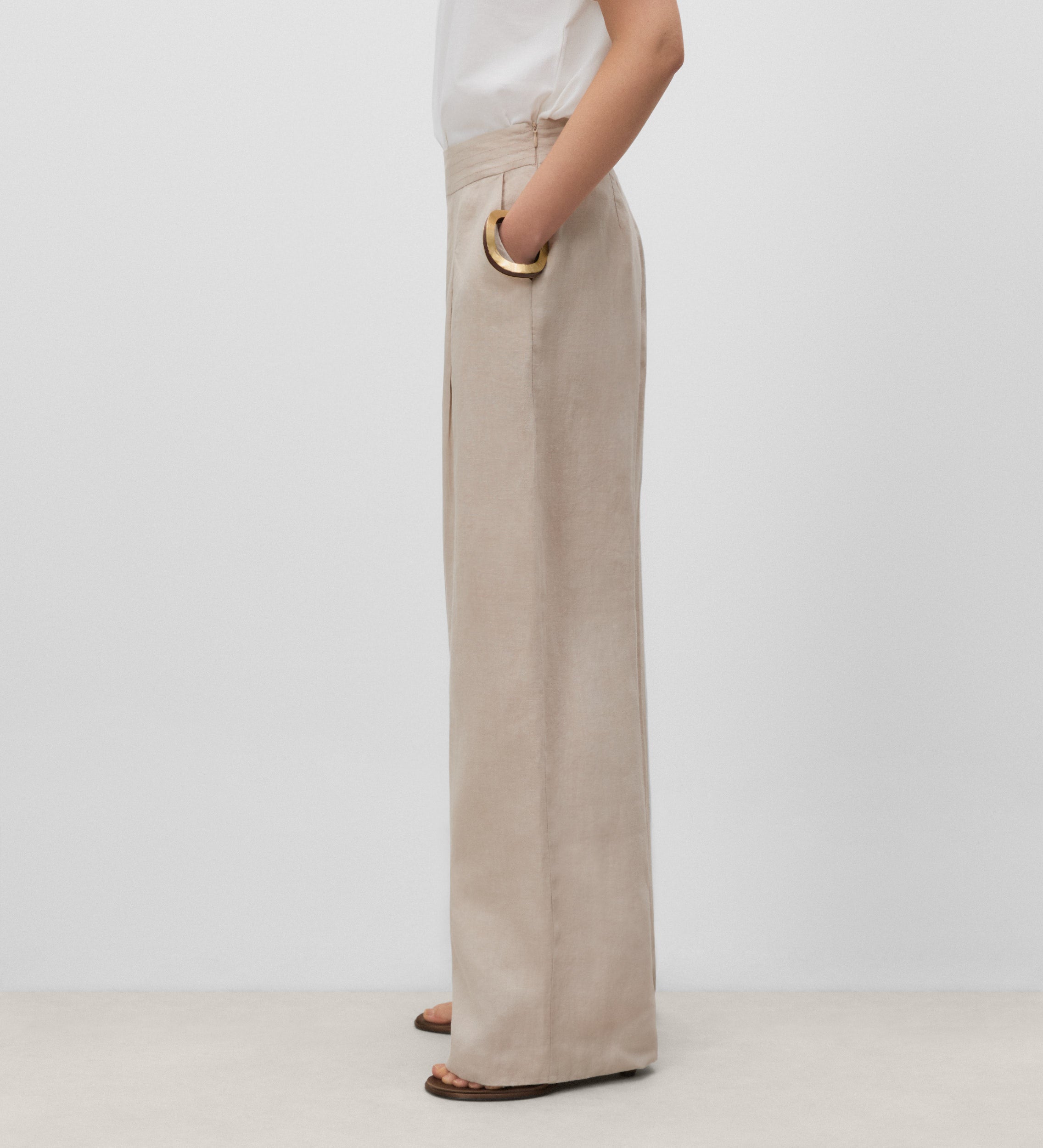Trousers with stitched waistband